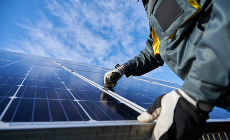 Male worker repairing photovoltaic solar panel